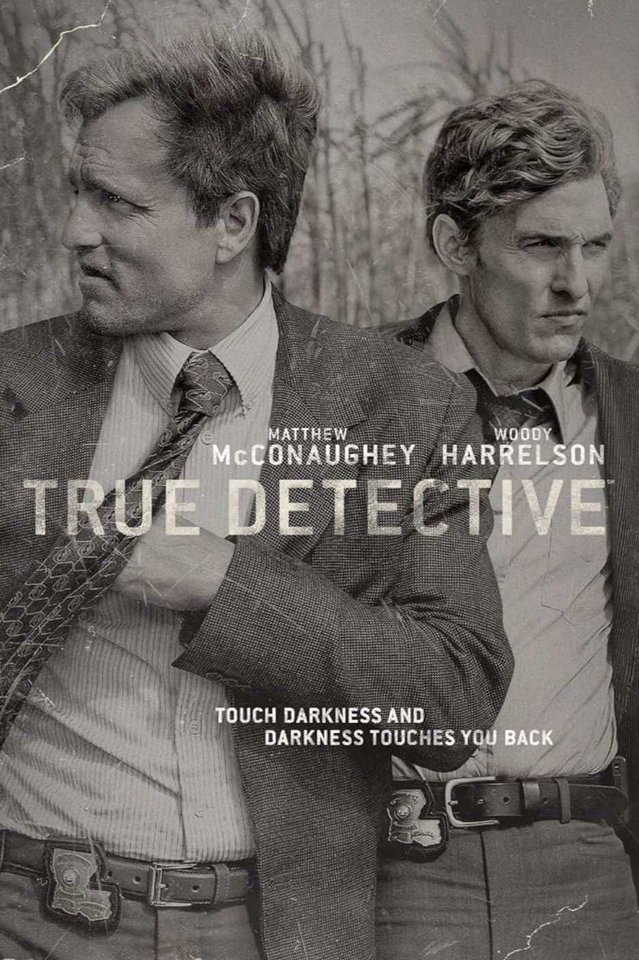 Two men in suits stand side by side, looking in different directions. The text reads: Matthew McConaughey, Woody Harrelson, True Detective. Experience the mystery like never before—stream now on Colombia IPTV. Touch darkness and darkness touches you back.